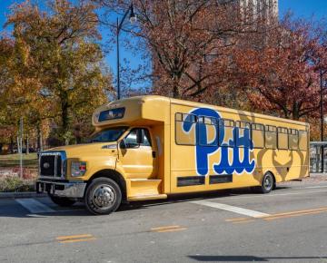Pitt shuttle in front of Cathedral of Learning